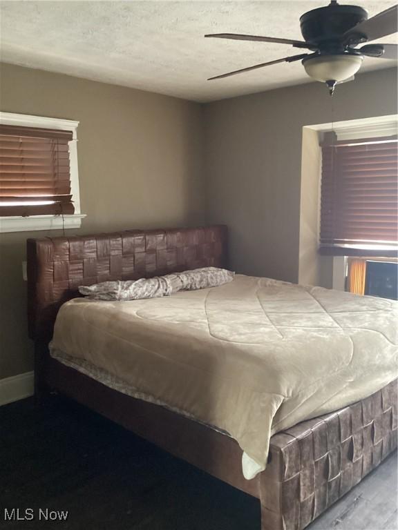 bedroom with a textured ceiling and ceiling fan