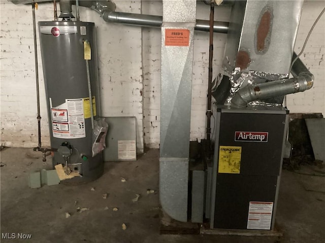 utility room featuring water heater and heating unit