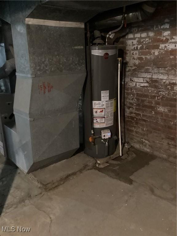 utility room featuring water heater and heating unit