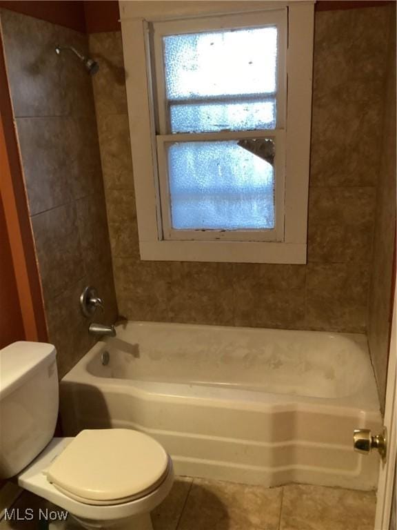 bathroom with toilet, shower / washtub combination, and tile patterned flooring