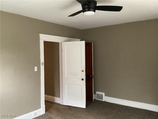 empty room featuring a ceiling fan, baseboards, visible vents, and carpet floors