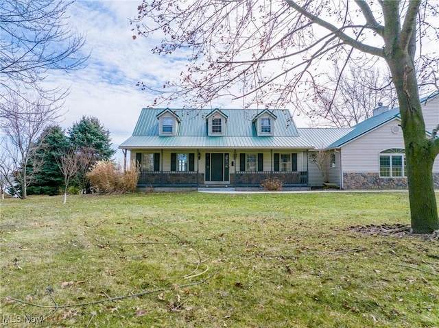 view of front of property featuring covered porch, metal roof, and a front lawn