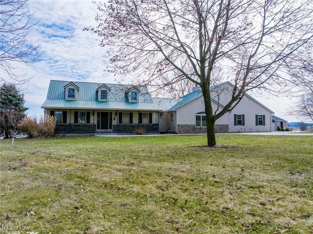 view of front of house with metal roof, a porch, and a front yard