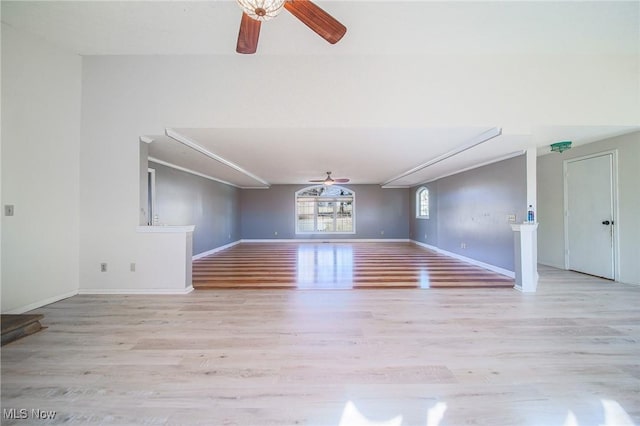 unfurnished living room with baseboards, light wood-style floors, and a ceiling fan