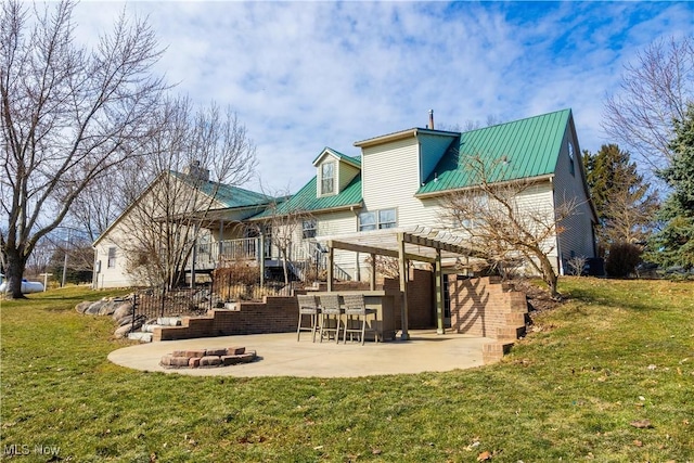 back of property with a yard, stairway, a pergola, and a patio area