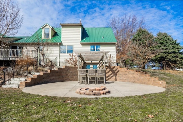 back of house featuring a pergola, a patio, fence, an outdoor fire pit, and metal roof