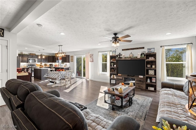 living area with recessed lighting, a healthy amount of sunlight, a textured ceiling, and dark wood-style flooring