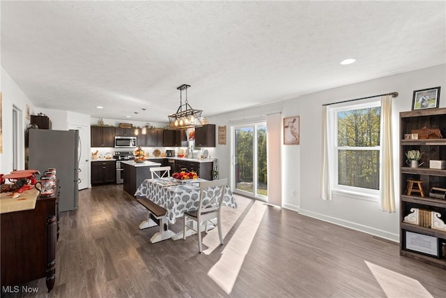 dining room featuring recessed lighting, baseboards, a textured ceiling, and dark wood-style flooring