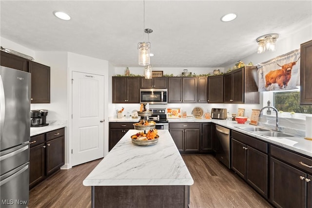 kitchen featuring a sink, stainless steel appliances, light countertops, dark brown cabinets, and dark wood-style flooring