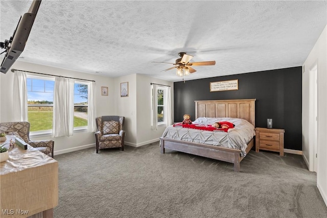 bedroom featuring a ceiling fan, carpet, baseboards, and a textured ceiling