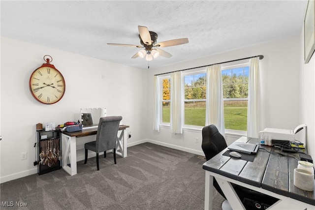 home office with baseboards, a ceiling fan, dark colored carpet, and a textured ceiling