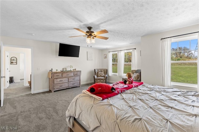 carpeted bedroom with a ceiling fan, baseboards, and a textured ceiling