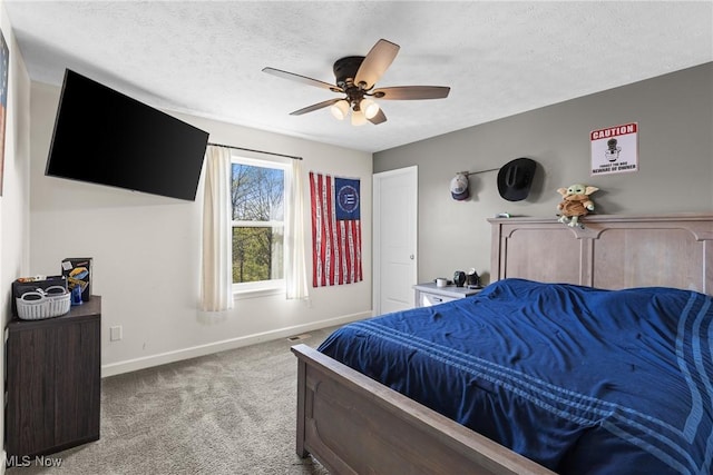 carpeted bedroom with a ceiling fan, baseboards, and a textured ceiling