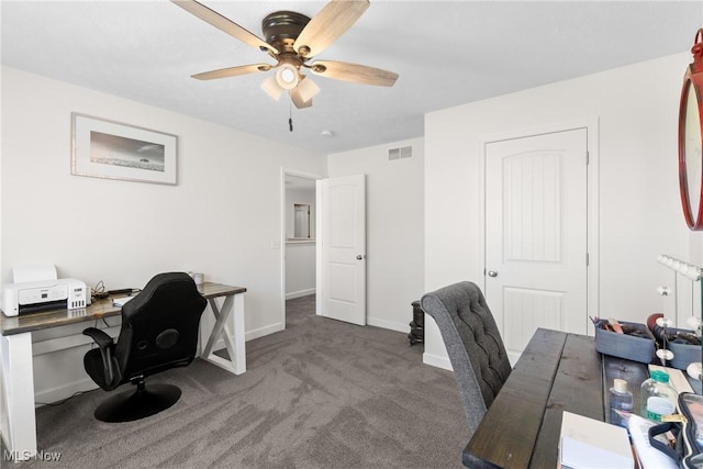 carpeted home office featuring a ceiling fan, visible vents, and baseboards