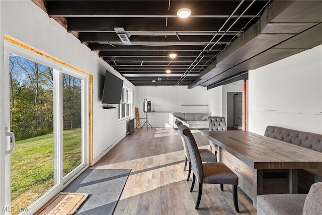 dining space with wood finished floors