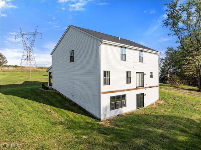 view of property exterior featuring a lawn