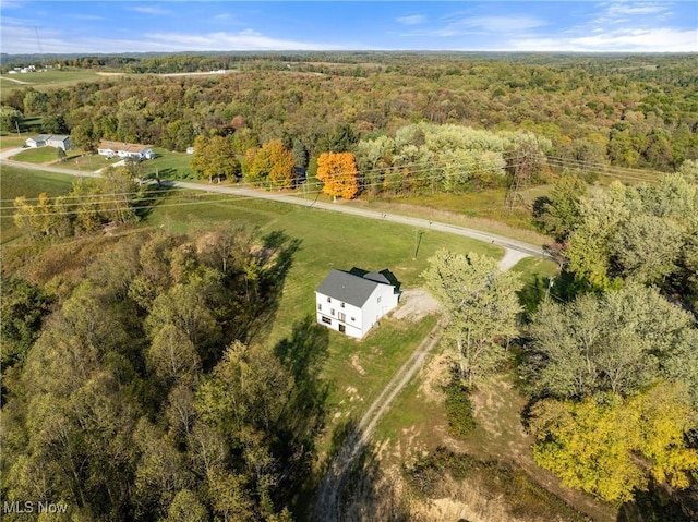 birds eye view of property featuring a wooded view