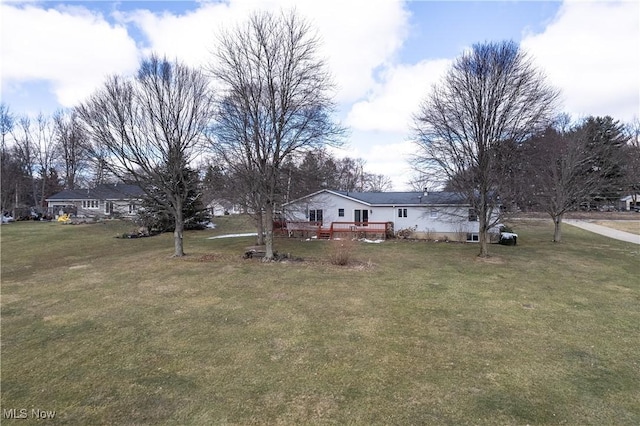 exterior space featuring a deck and a front yard