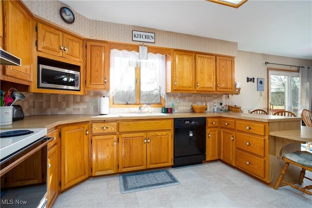 kitchen with stainless steel microwave, wallpapered walls, white range with electric cooktop, dishwasher, and a peninsula