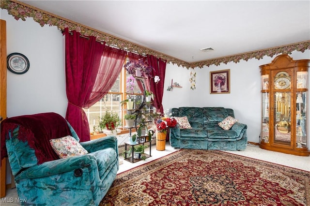 carpeted living room with visible vents and baseboard heating