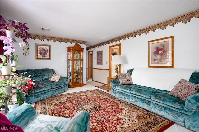 living area featuring visible vents and carpet