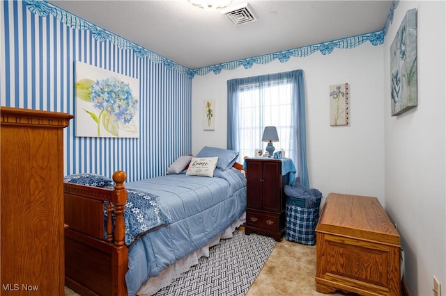 bedroom with visible vents and carpet floors