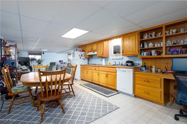 kitchen featuring white appliances, built in study area, open shelves, light countertops, and under cabinet range hood