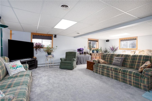 carpeted living room featuring a baseboard heating unit, a paneled ceiling, and visible vents