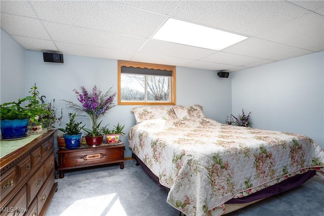 carpeted bedroom featuring a paneled ceiling