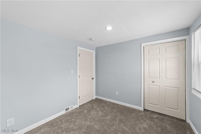 unfurnished bedroom featuring visible vents, recessed lighting, baseboards, and carpet floors