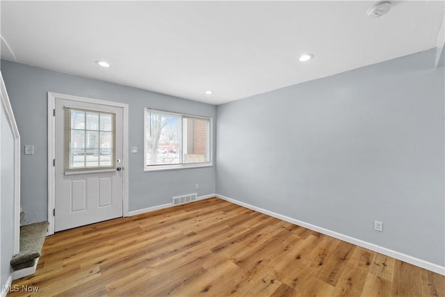 foyer with recessed lighting, visible vents, light wood-style flooring, and baseboards