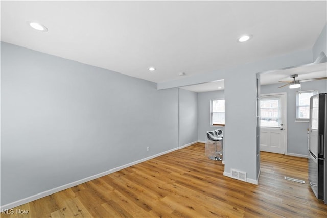 unfurnished living room with recessed lighting, light wood-style floors, visible vents, and baseboards