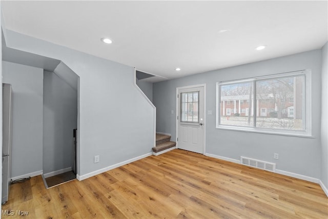 foyer entrance with visible vents, recessed lighting, stairs, and light wood-style floors