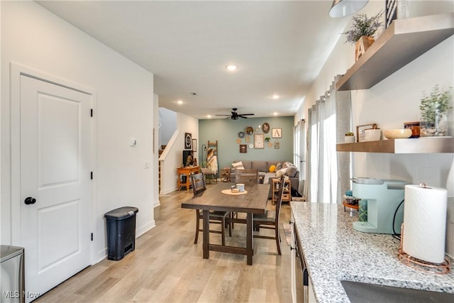 dining room featuring a ceiling fan, baseboards, recessed lighting, stairs, and light wood-type flooring