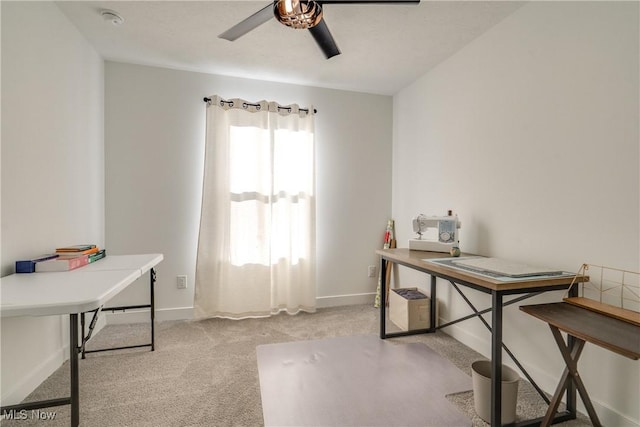 office area with light colored carpet, baseboards, and ceiling fan