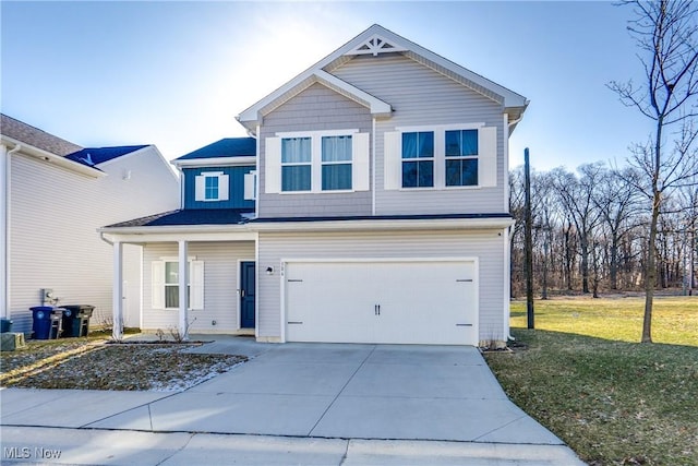 view of front of property featuring a garage, a front lawn, and driveway