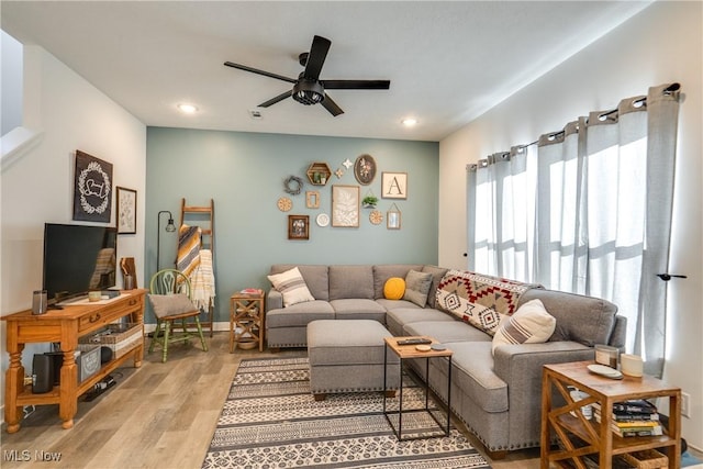 living area with recessed lighting, baseboards, light wood-style floors, and ceiling fan