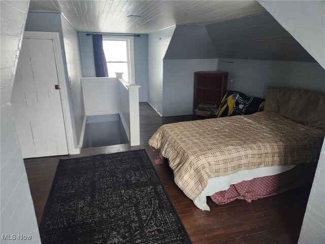 bedroom featuring lofted ceiling and wood finished floors