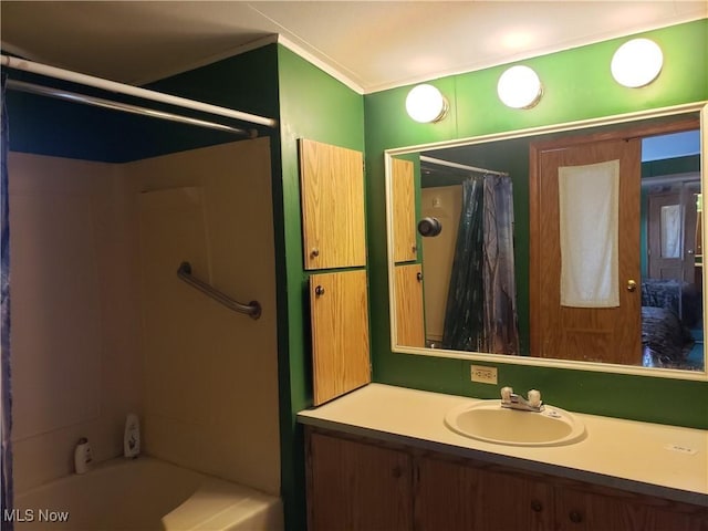 full bathroom with vanity, crown molding, and shower / tub combo