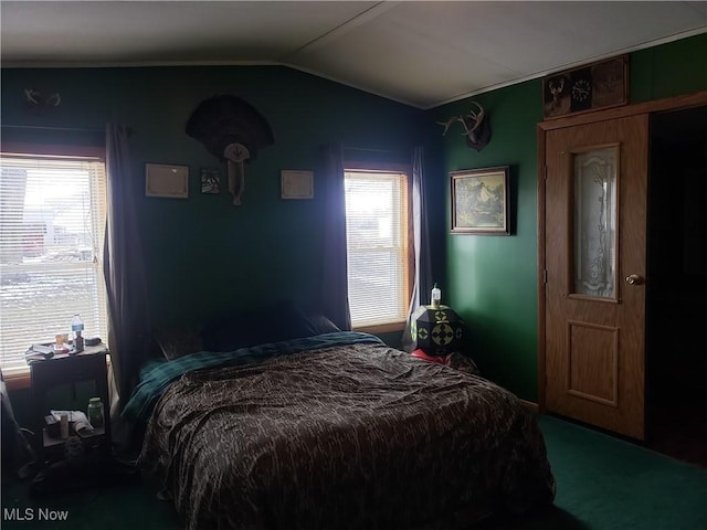 carpeted bedroom featuring vaulted ceiling