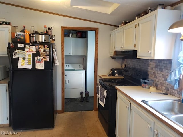 kitchen with washer / clothes dryer, a sink, black appliances, under cabinet range hood, and tasteful backsplash