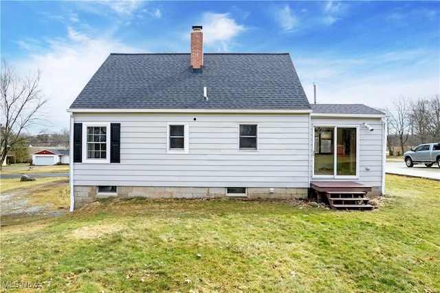 back of house featuring a yard, roof with shingles, and a chimney