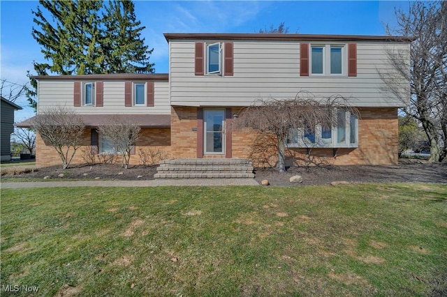 view of front of property with brick siding and a front lawn