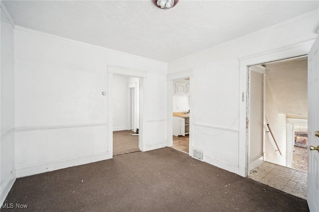 unfurnished bedroom with visible vents and crown molding