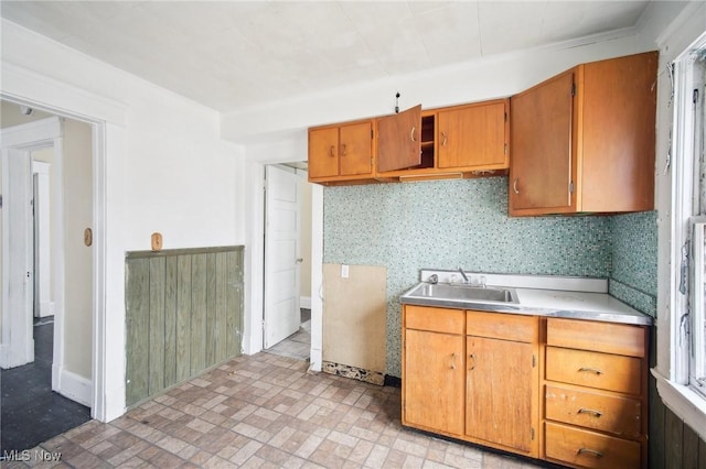 kitchen with brown cabinets, light countertops, and a sink