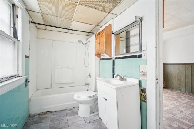 full bathroom with vanity, toilet, a wealth of natural light, and wainscoting