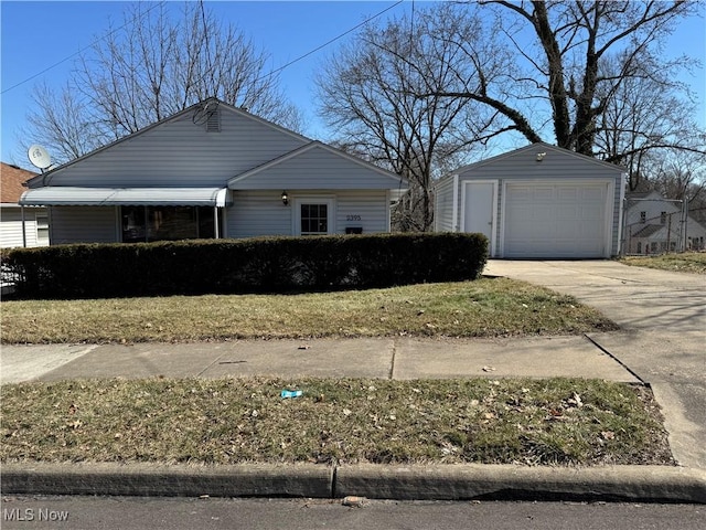 view of front of property featuring a garage, an outdoor structure, and concrete driveway