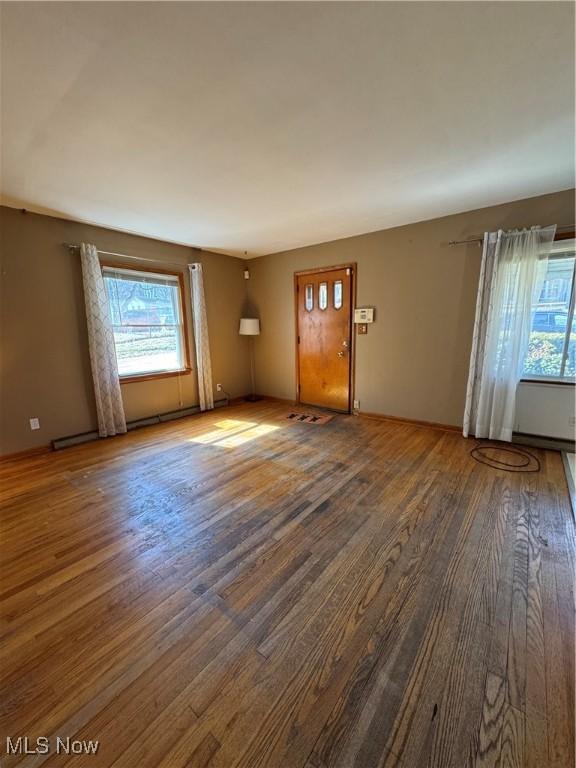 unfurnished living room featuring wood finished floors