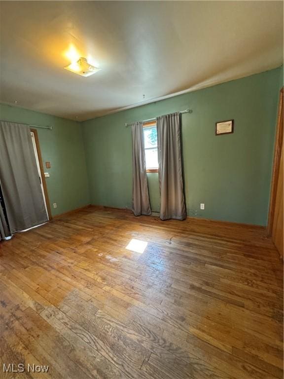 empty room with wood-type flooring