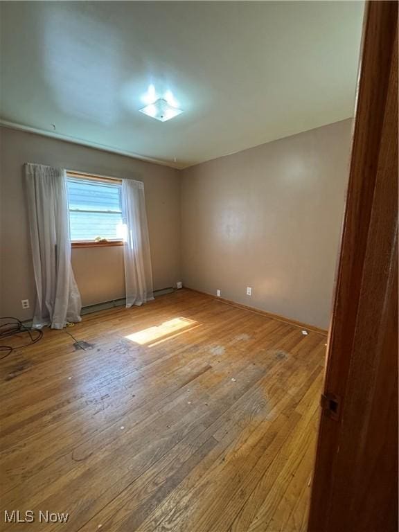 empty room with wood-type flooring